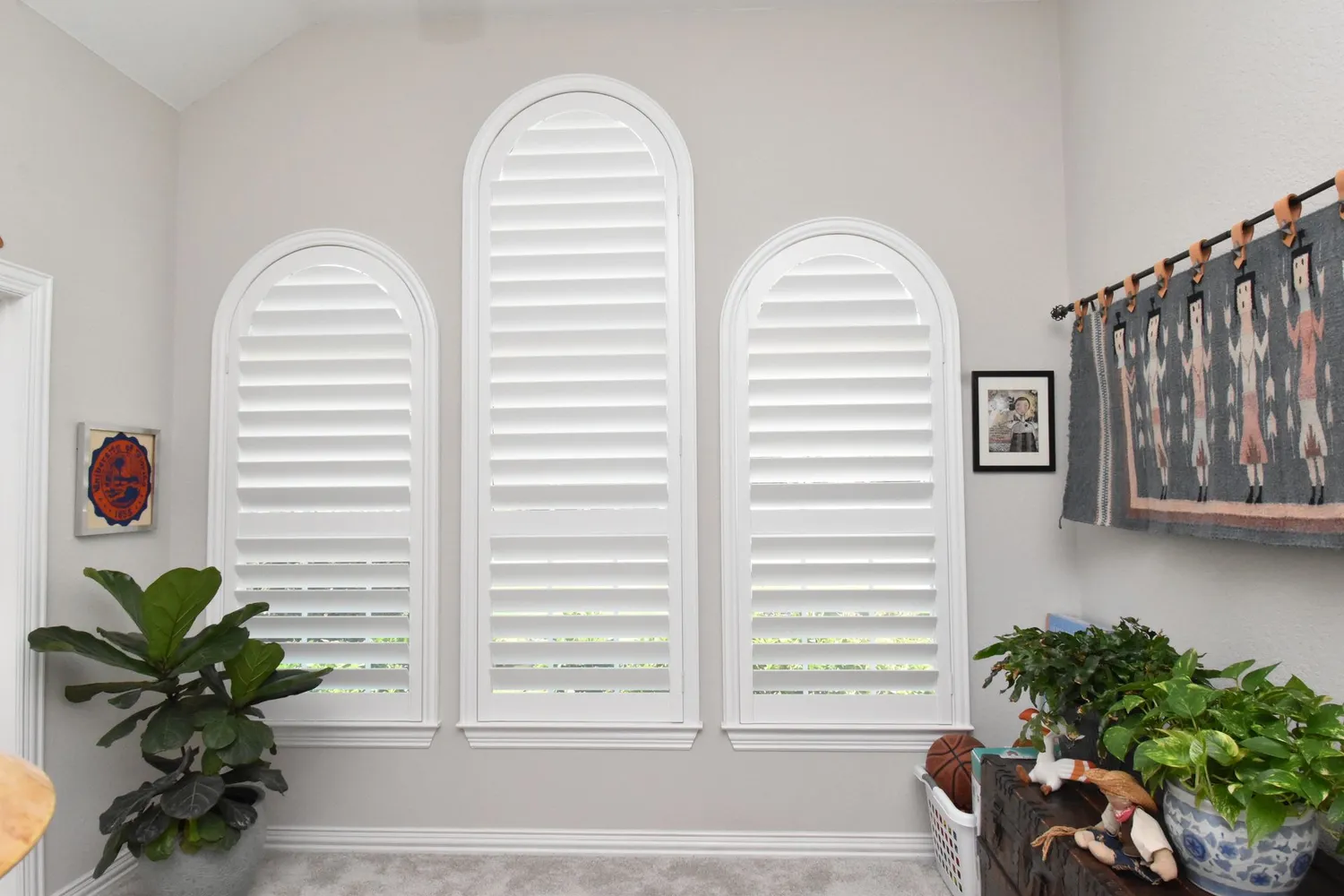 white arched plantation shutters